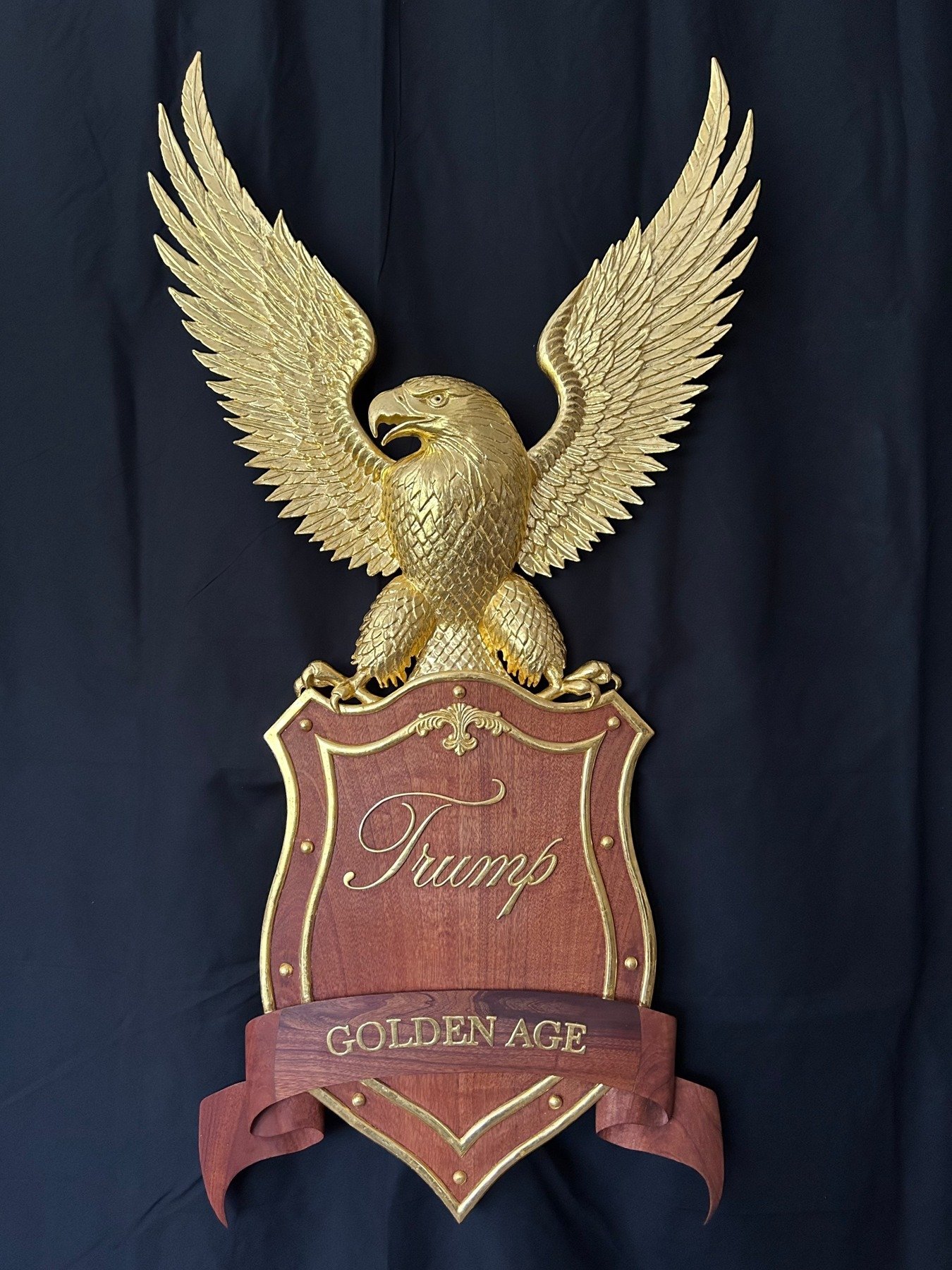 Golden Age: gilded eagle over a carved shield